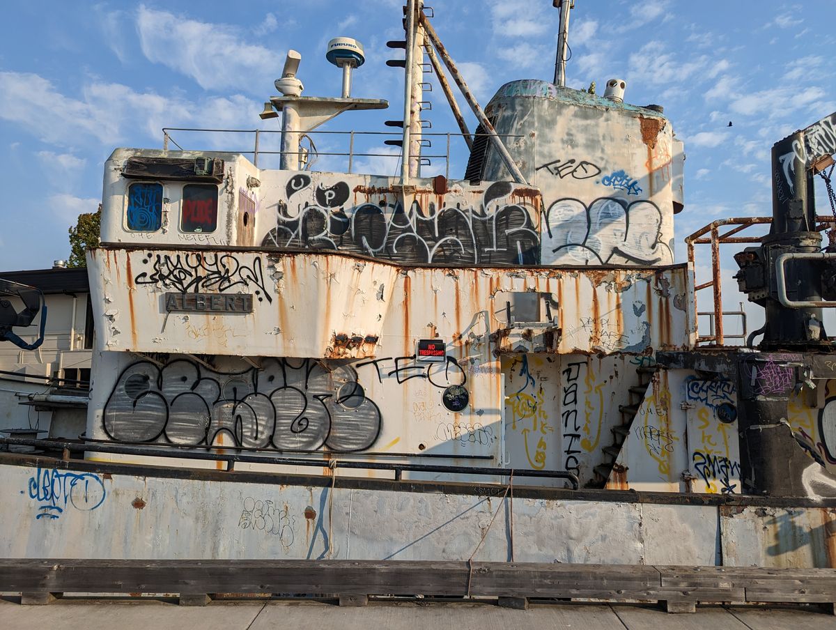 Pixel 7 wide shot of the side of a boat with graffiti