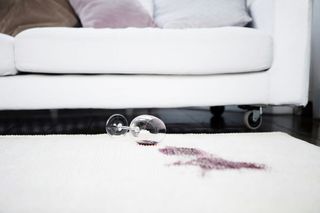 red wine spilled on a white carpet