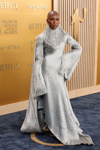 Cynthia Erivo wears a metallic silver gown with a high collar at the 2025 SAG Awards.