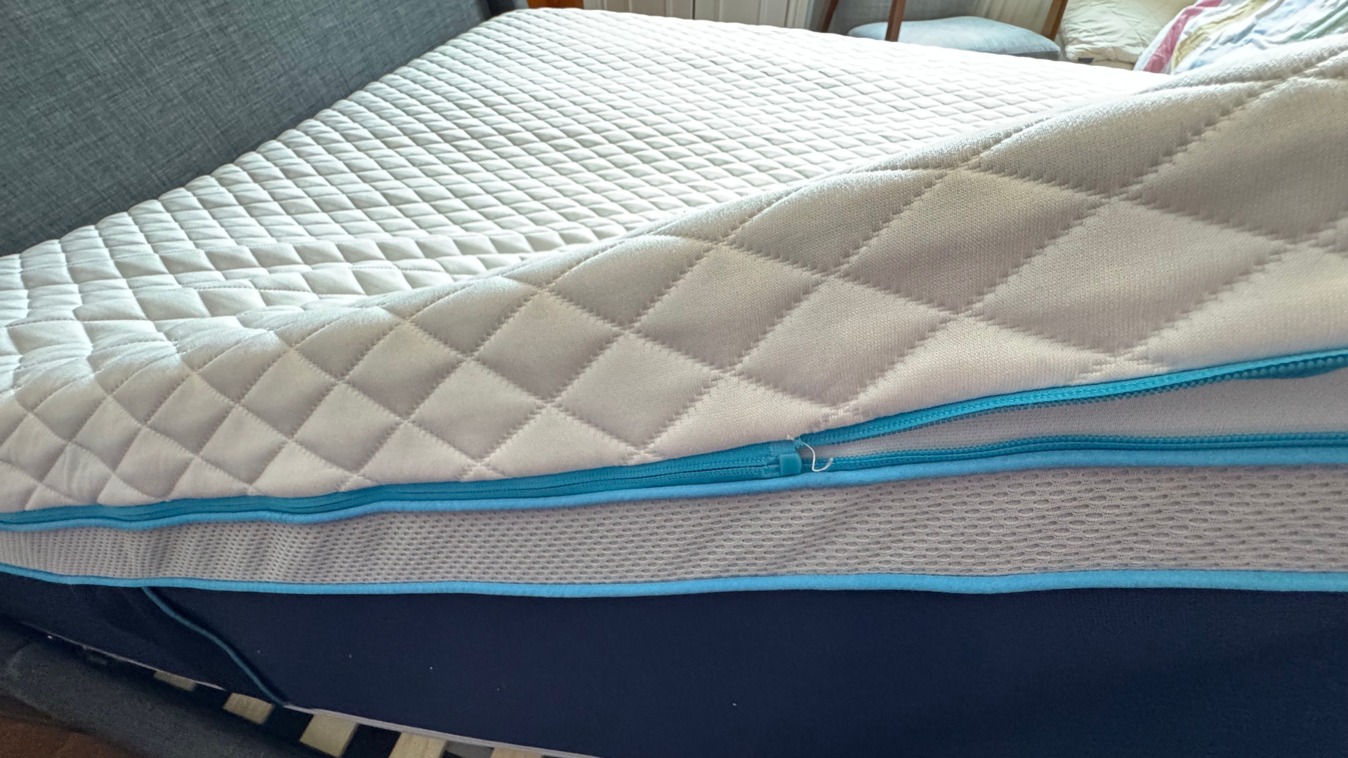 A shot of the Simba Hybrid Luxe mattress with the removable cover being unzipped