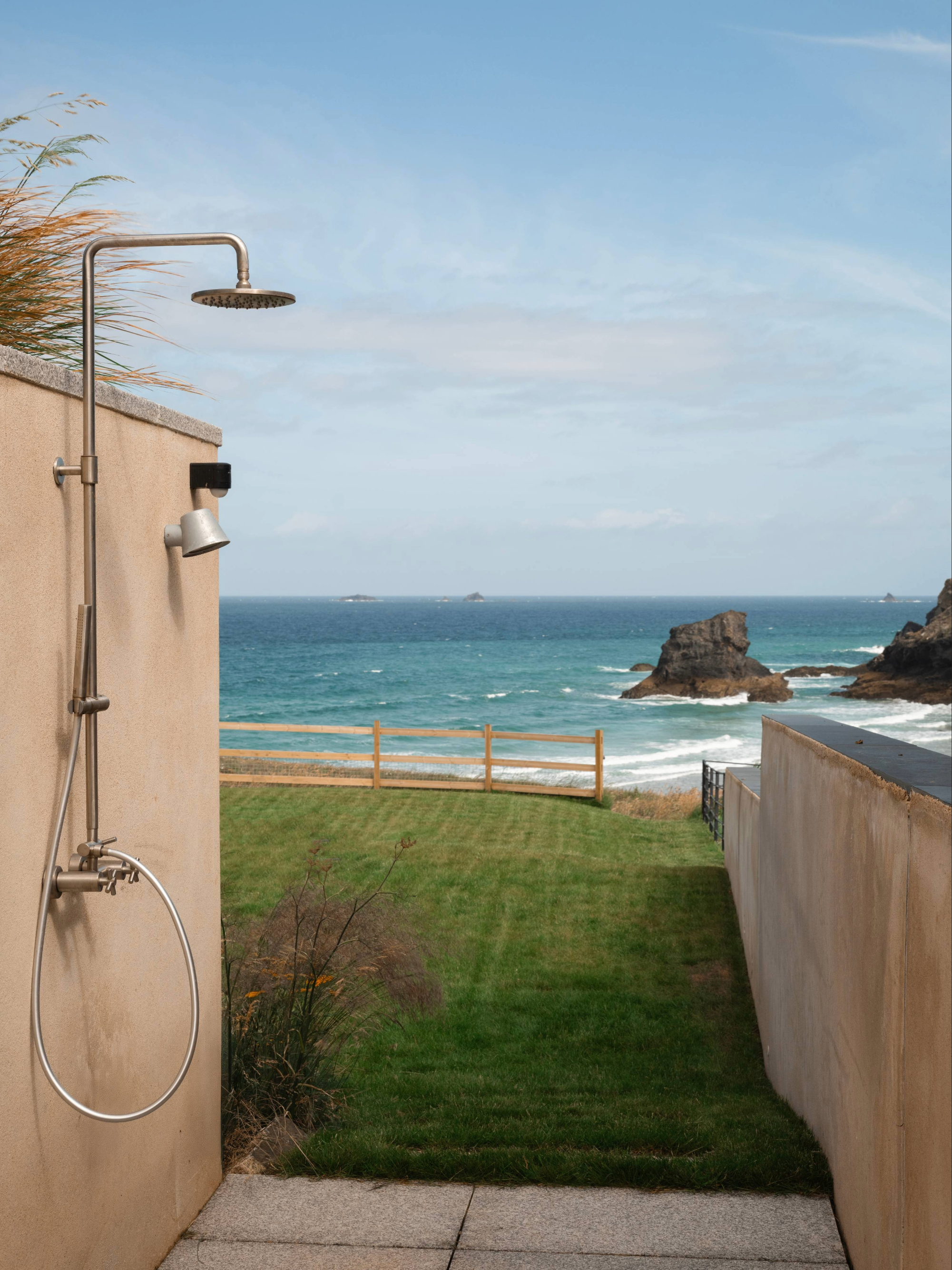 Outdoor shower with coastal backdrop