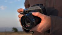 Hasselblad X2D II 100C being used by a photographer outdoors