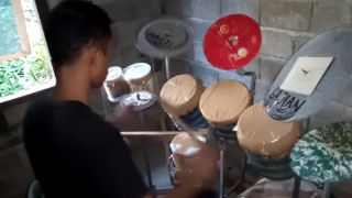 Deden Noy performing on his homemade drum kit