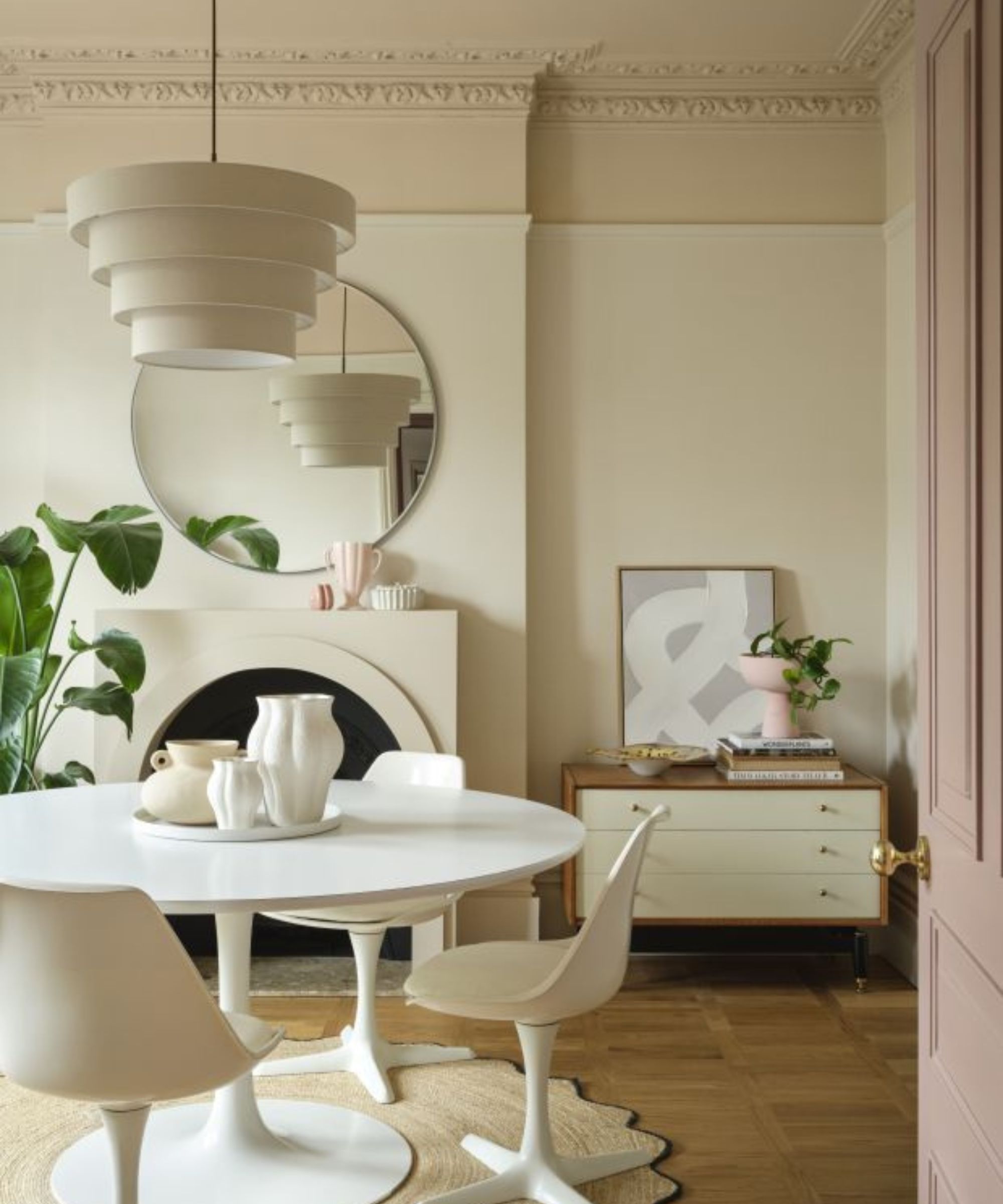 period home with a modern neutral styled dining room with warm white walls and a darker taupe painted ceiling and contemporary white furniture