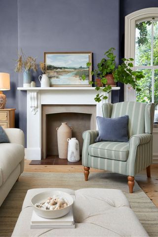 blue living room with fireplace and armchair