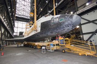 In the Vehicle Assembly Building at NASA's Kennedy Space Center in Florida, an overhead crane slowly lifts shuttle Atlantis off its transporter. NASA plans to launch Atlantis on the final space shuttle mission, STS-135, in mid-July.