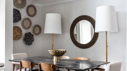 a dining room with a basket gallery wall