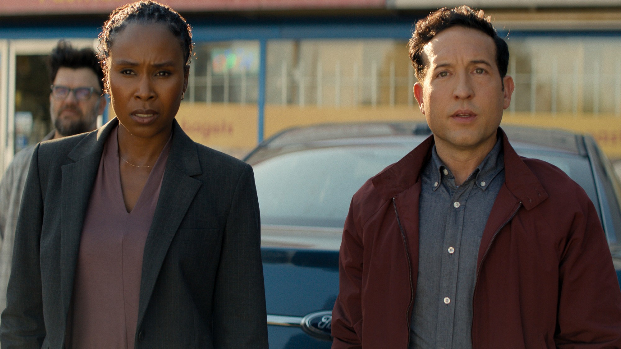 From left to right: Tamara and Jacob standing together in Reacher. 