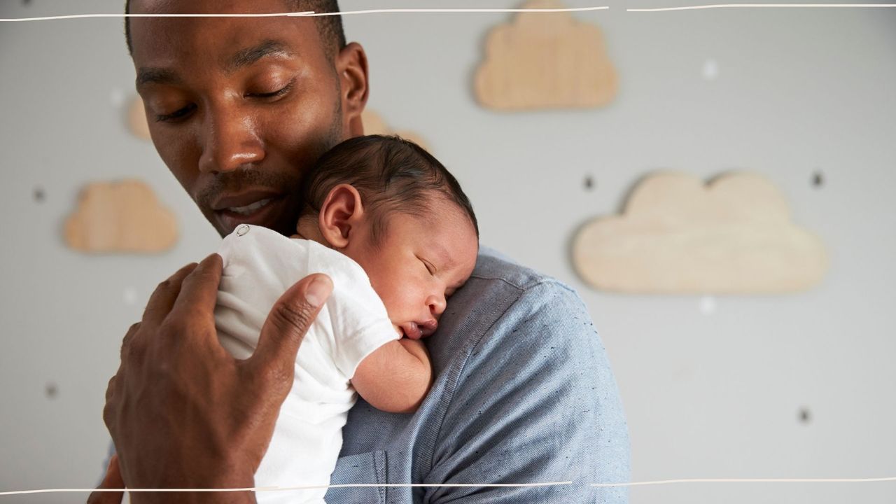 Dad holding newborn baby