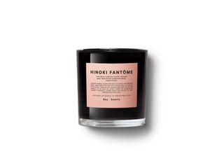 Boy Smells Hinoki Fantome candle features a black jar covered in a pink label, all sitting against a white background.