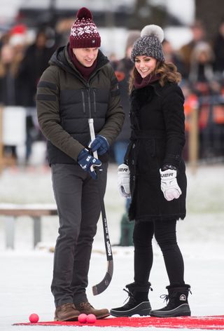 Prince William and Kate Middleton playing ice hockey