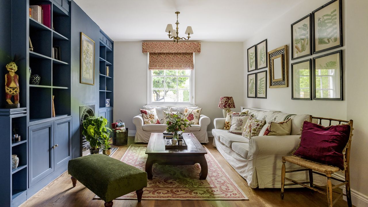 open plan living room with blue built in bookshelves and white sofa