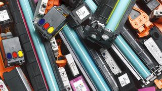 Ink cartridges of various types and sizes piled on top of each other
