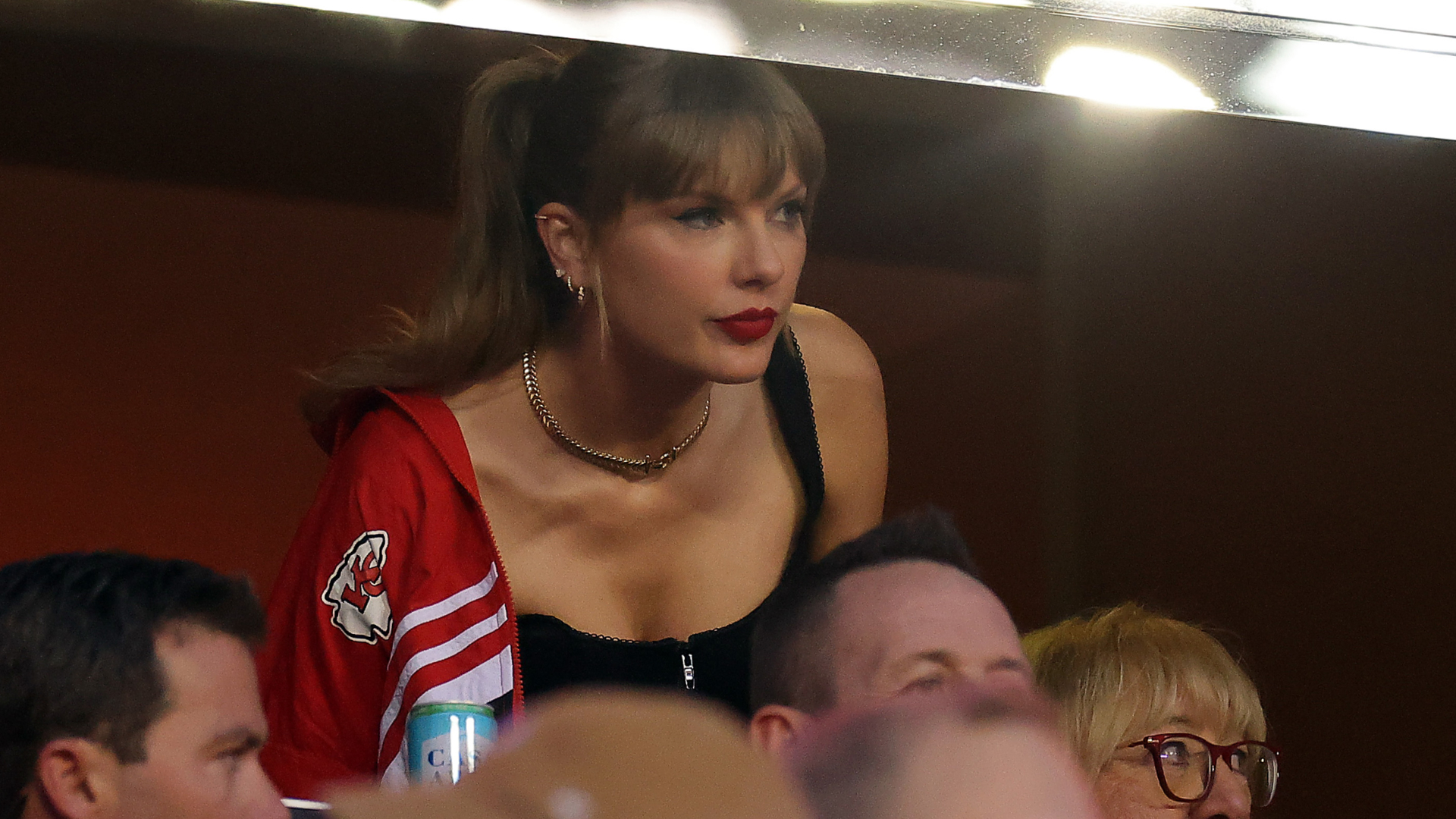 Taylor Swift attending the Kansas City Chiefs game wearing a vintage jacket