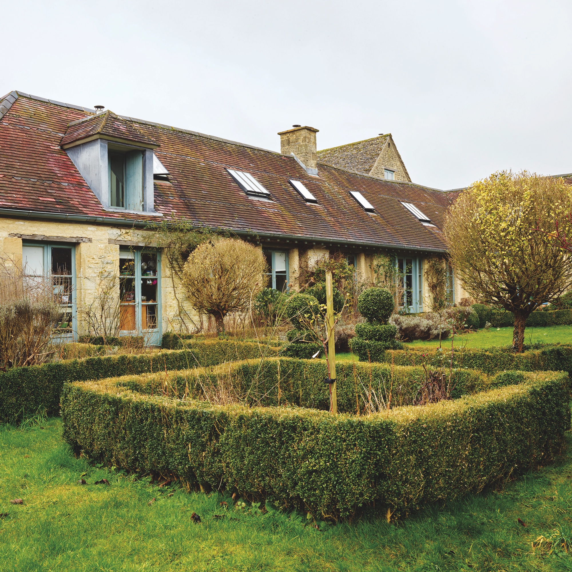 garden with box hedging and view of converted barn