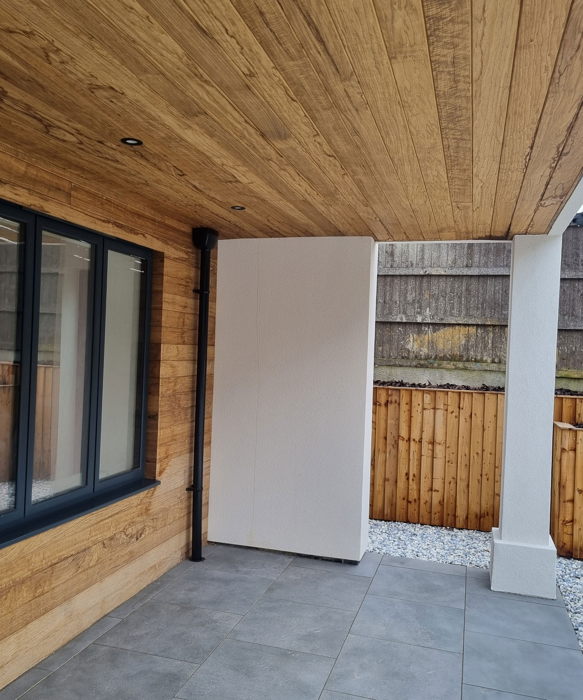 timber clad underside of flat roof modern porch