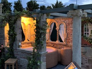 hot tub with gothic surrounding by Redwood Stone