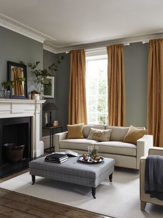 Living room with full height curtains by Neptune in mustard hues.