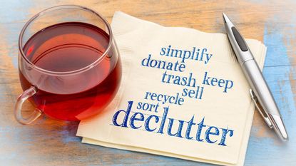 decluttering list with cup of tea