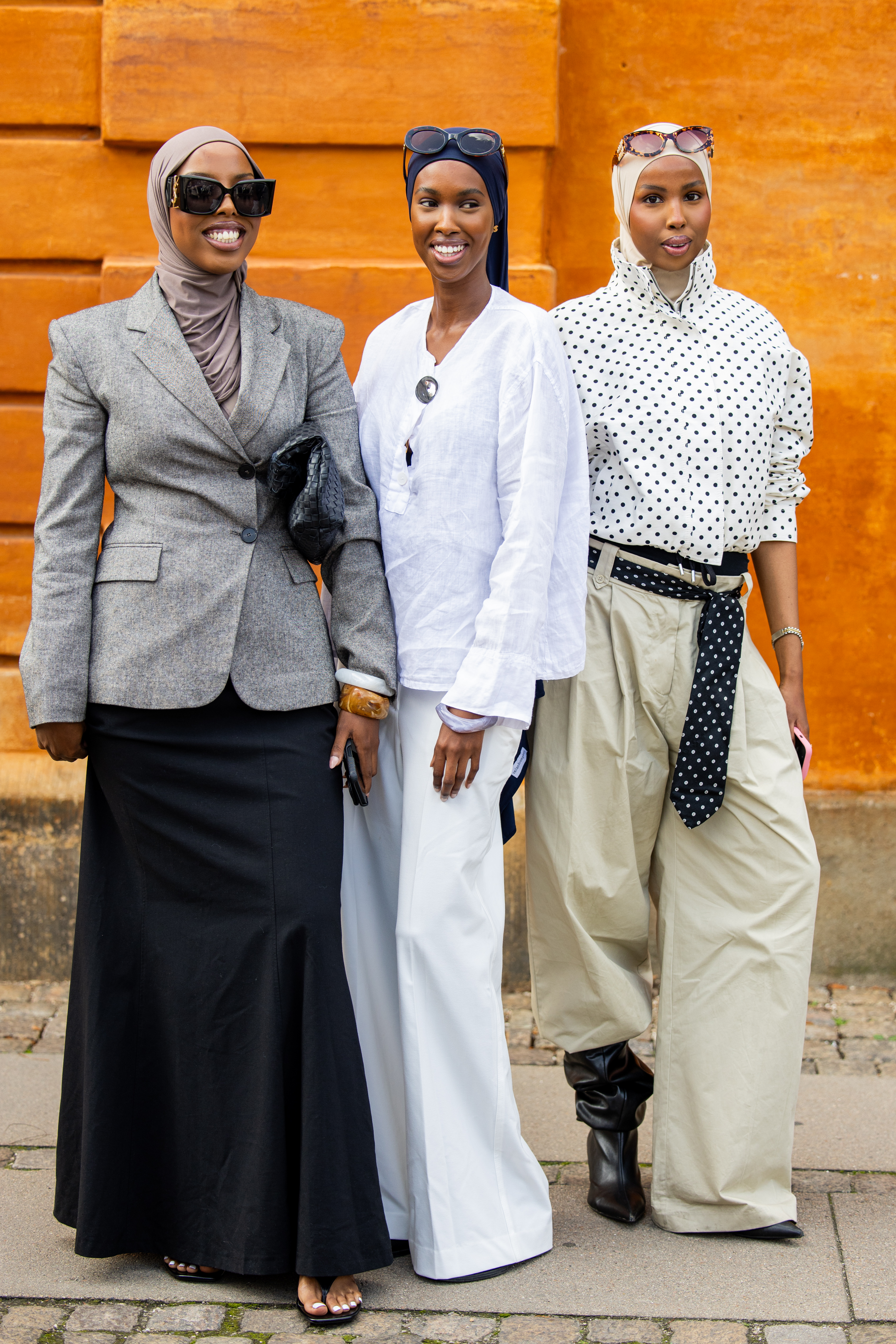 three women at copenhagen fashion week wearing thong sandals and blazers