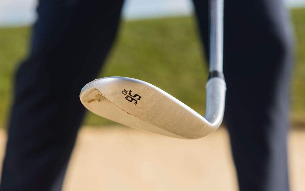 How to open the club face in golf swing: Image of a wedge with an open club face