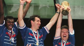 France captain Didier Deschamps lifts the trophy, flanked by teammates Marcel Desailly and Laurent Blanc, after France beat Brazil in the final to win the 1998 FIFA World Cup in France
