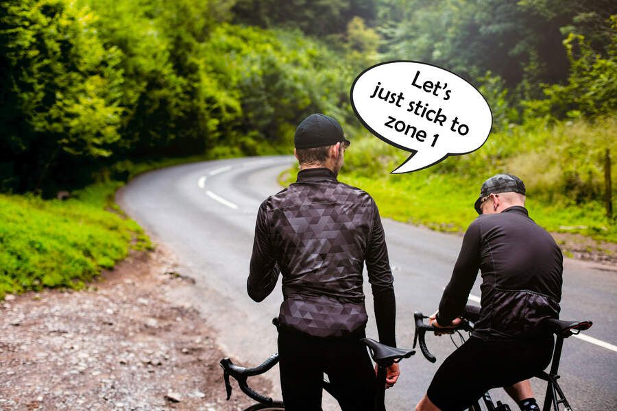 Two cyclists side by side with one suggesting they ride at zone one