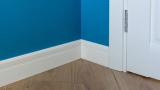 deep white skirting board with blue wall