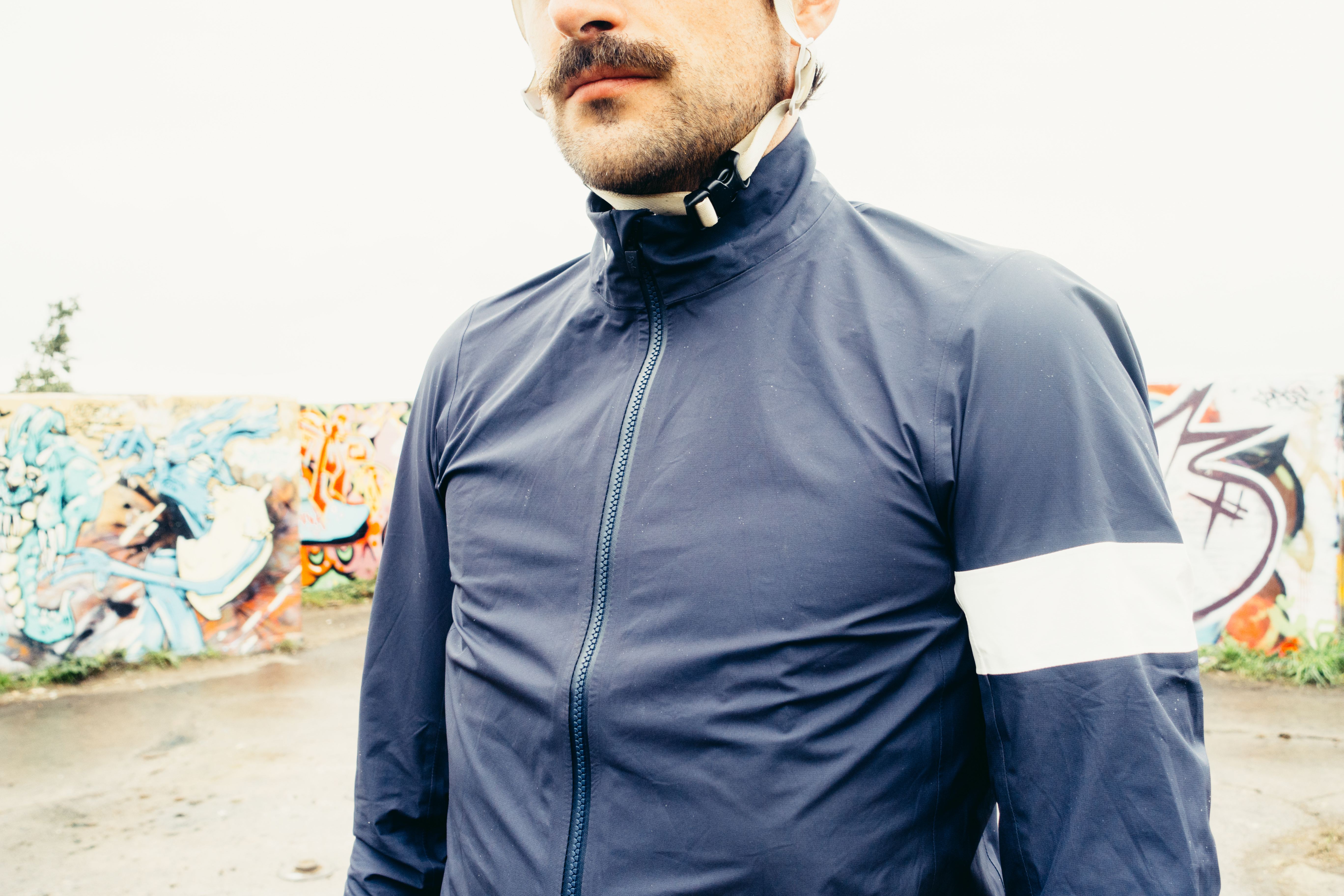 A close up of the chest of a navy waterproof cycling jacket