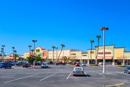Florida strip mall with cars in parking lot for Florida tax holiday story