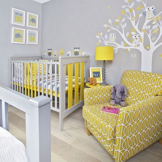 grey nursery with yellow armchair and crib