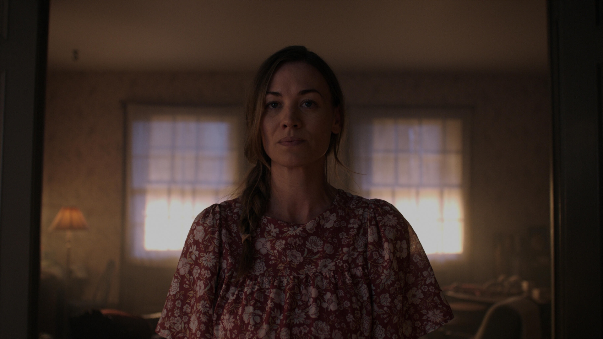 Serena stands with a floral top on alone in a house in The Handmaid's Tale season 6