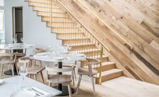 Restaurant with stairs and round shape table at Lurra, London, UK
