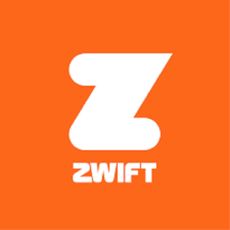 Cyclist riding a Zwift bike with the Zwift app on the wall in front of them in an orange room