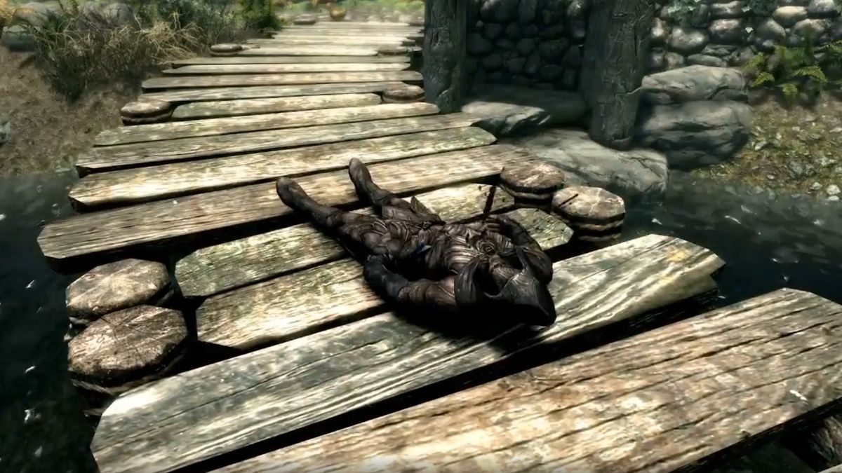 Skyrim player character bleeding out on a boardwalk.