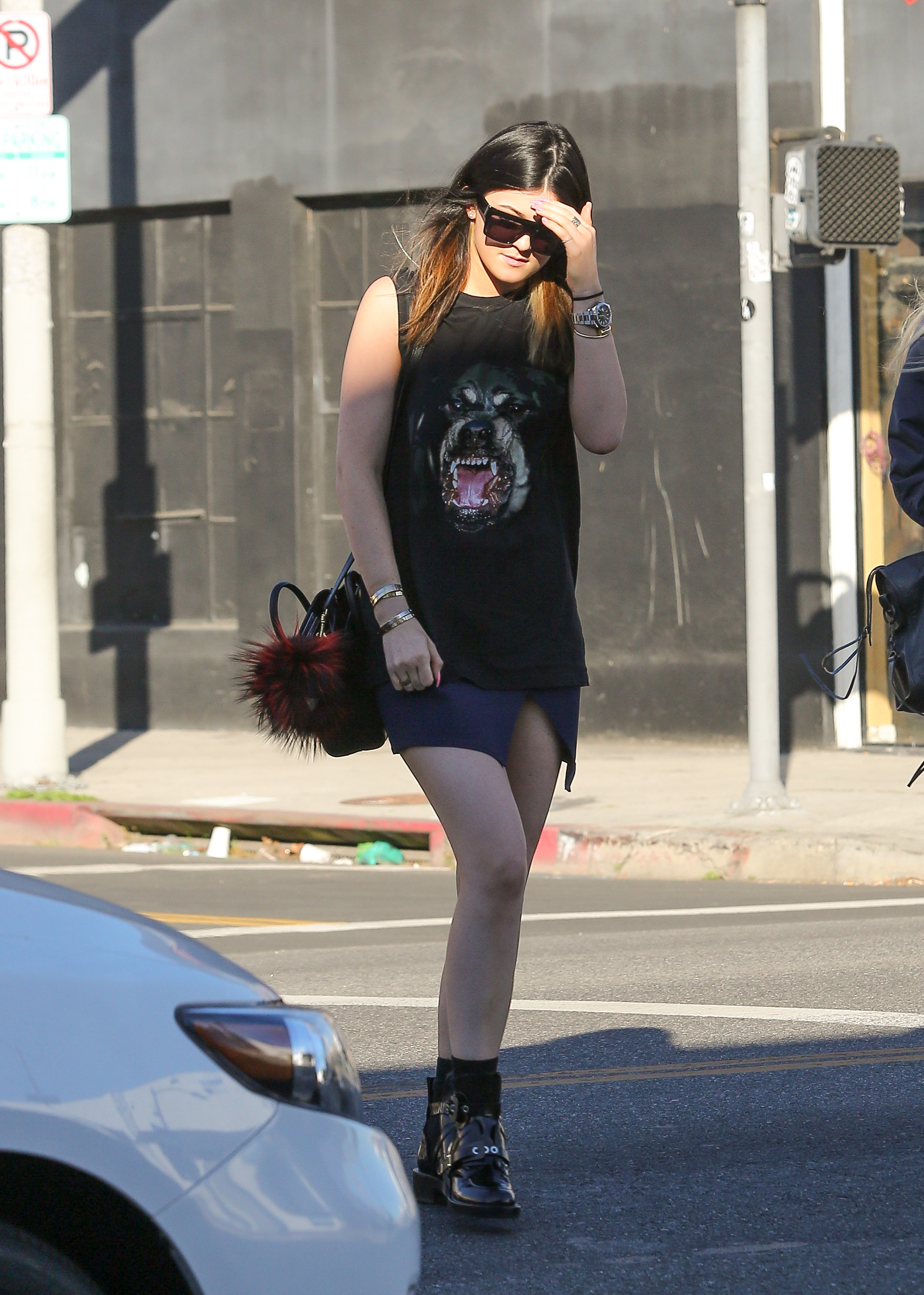 An image of Kylie Jenner wearing a Fendi bag charm, one of the biggest 2010 fashion trends, while out in Los Angeles in 2014.