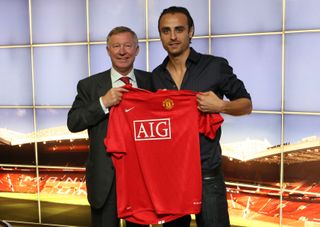 Dimitar Berbatov poses with Sir Alex Ferguson and a Manchester United shirt after signing for the club at Old Trafford on September 1, 2008 in Manchester, England.