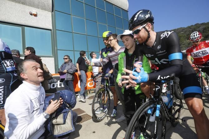 Bradley Wiggins takes a photo with a fan