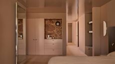 A biscuity pink/brown color-drenched bedroom with high-gloss ceiling