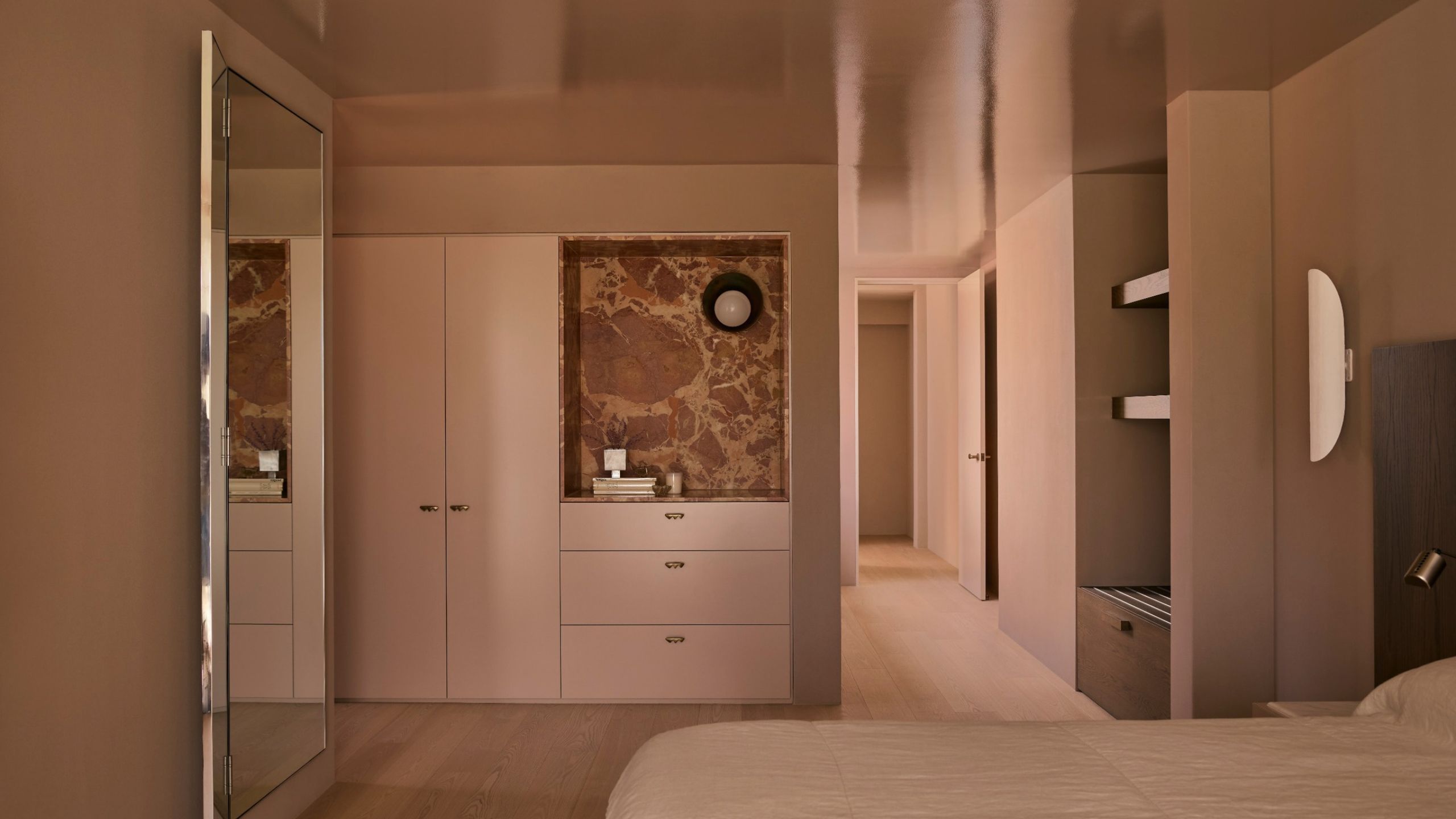 A biscuity pink/brown color-drenched bedroom with high-gloss ceiling