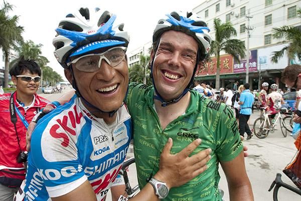 That's another beer Kenny: Stage winner Kenny 'The Hummer' Van Hummel (right) is congratulated by teammate Long Jin from China.