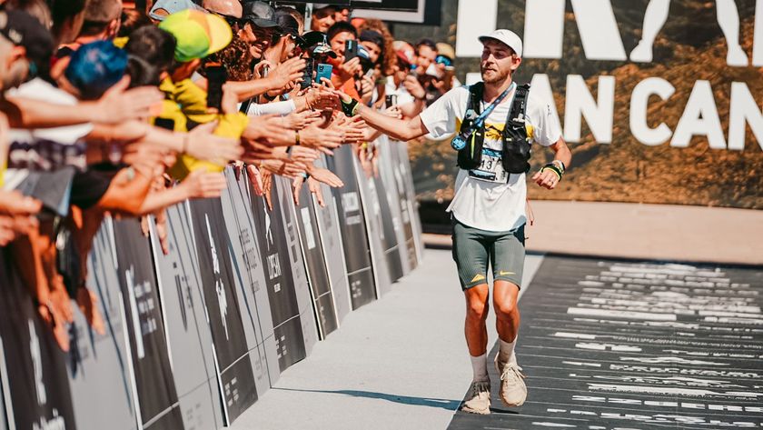 Caleb Olson high fiving spectators after winning the Transgrancanaria 2025