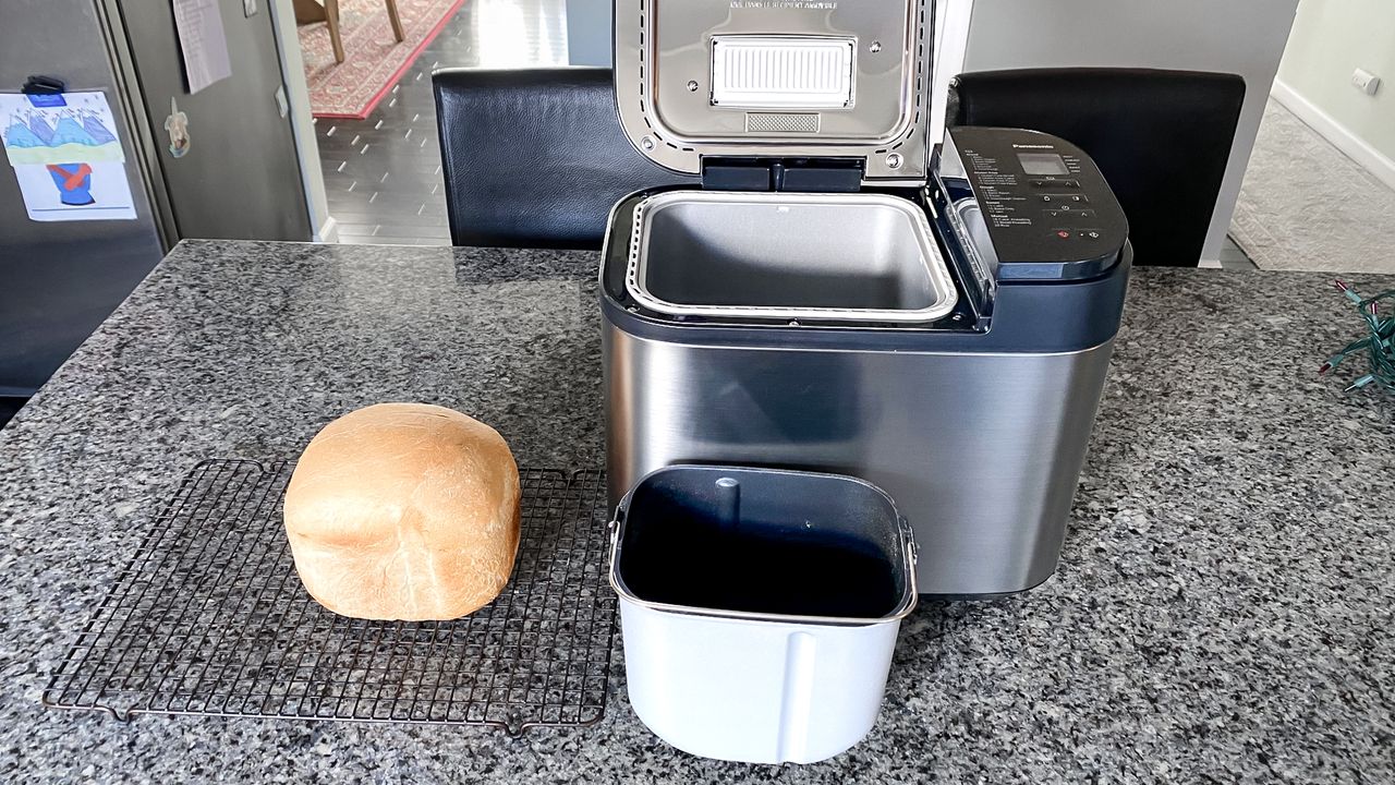 Panasonic Automatic Bread Maker on a kitchen counter with a cooked loaf of bread