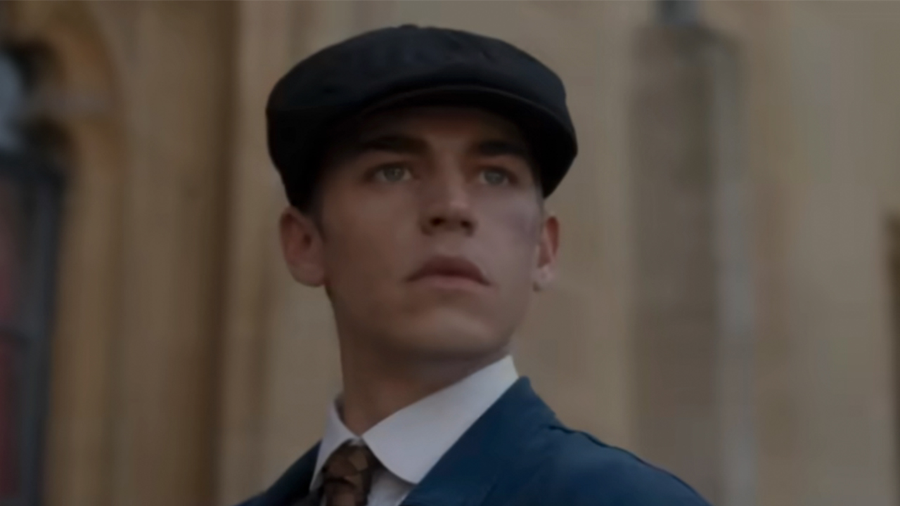 Hero Fiennes Tiffin in a hat and suit in Young Sherlock Holmes