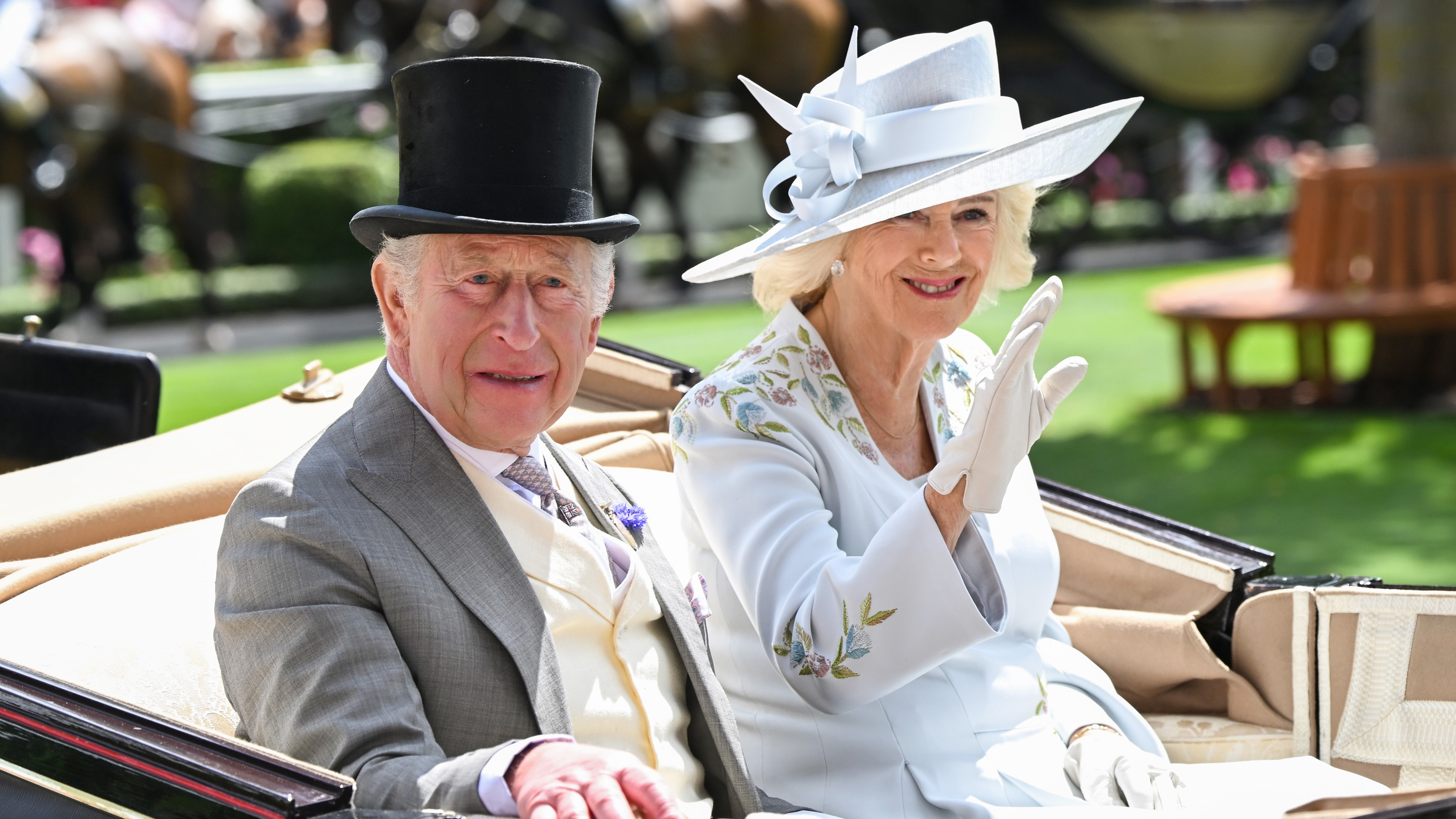 King Charles III and Queen Camilla smile and wave as they attend day one of Royal Ascot 2026