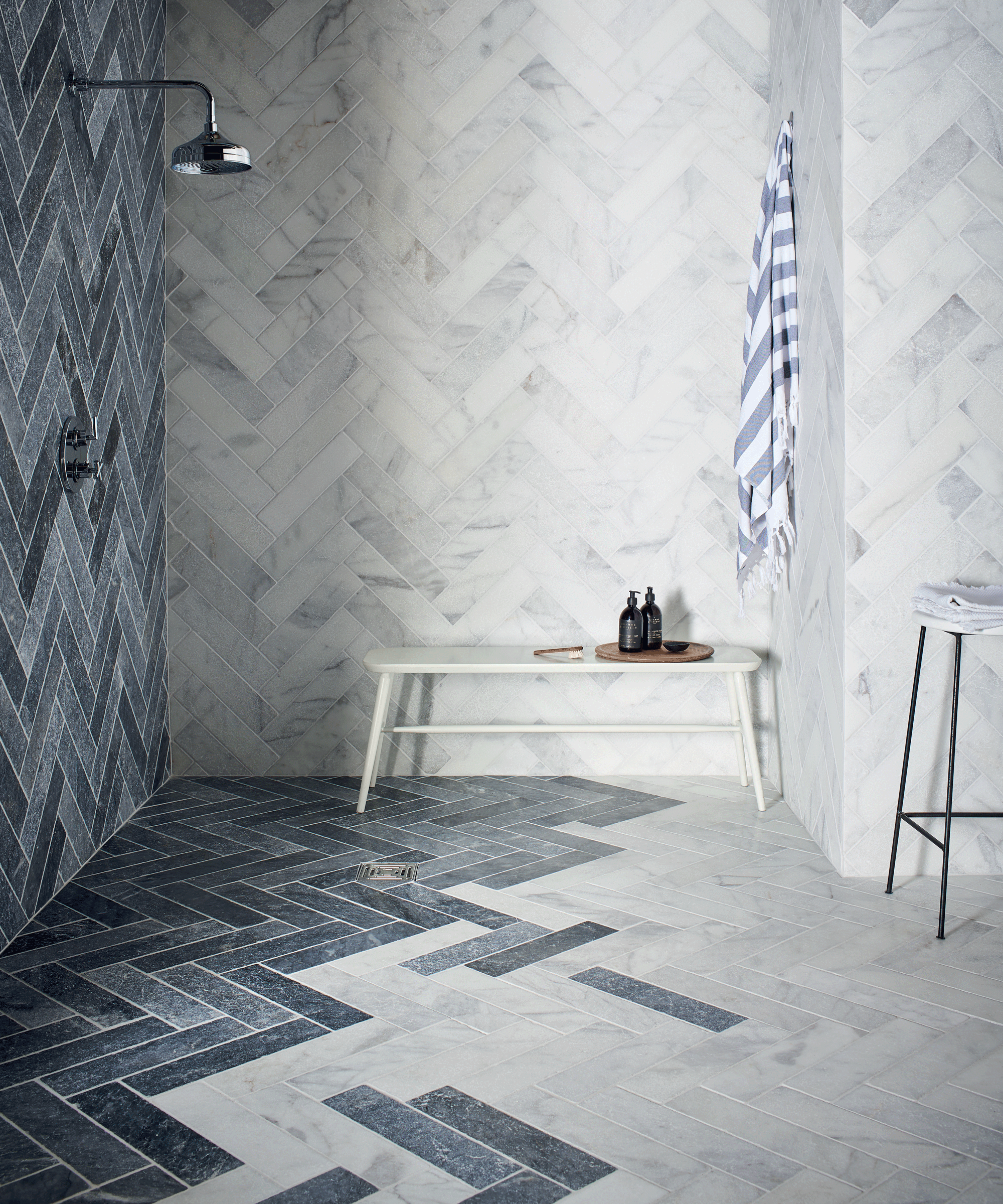 Shower with marble tiles laid in herringbone pattern