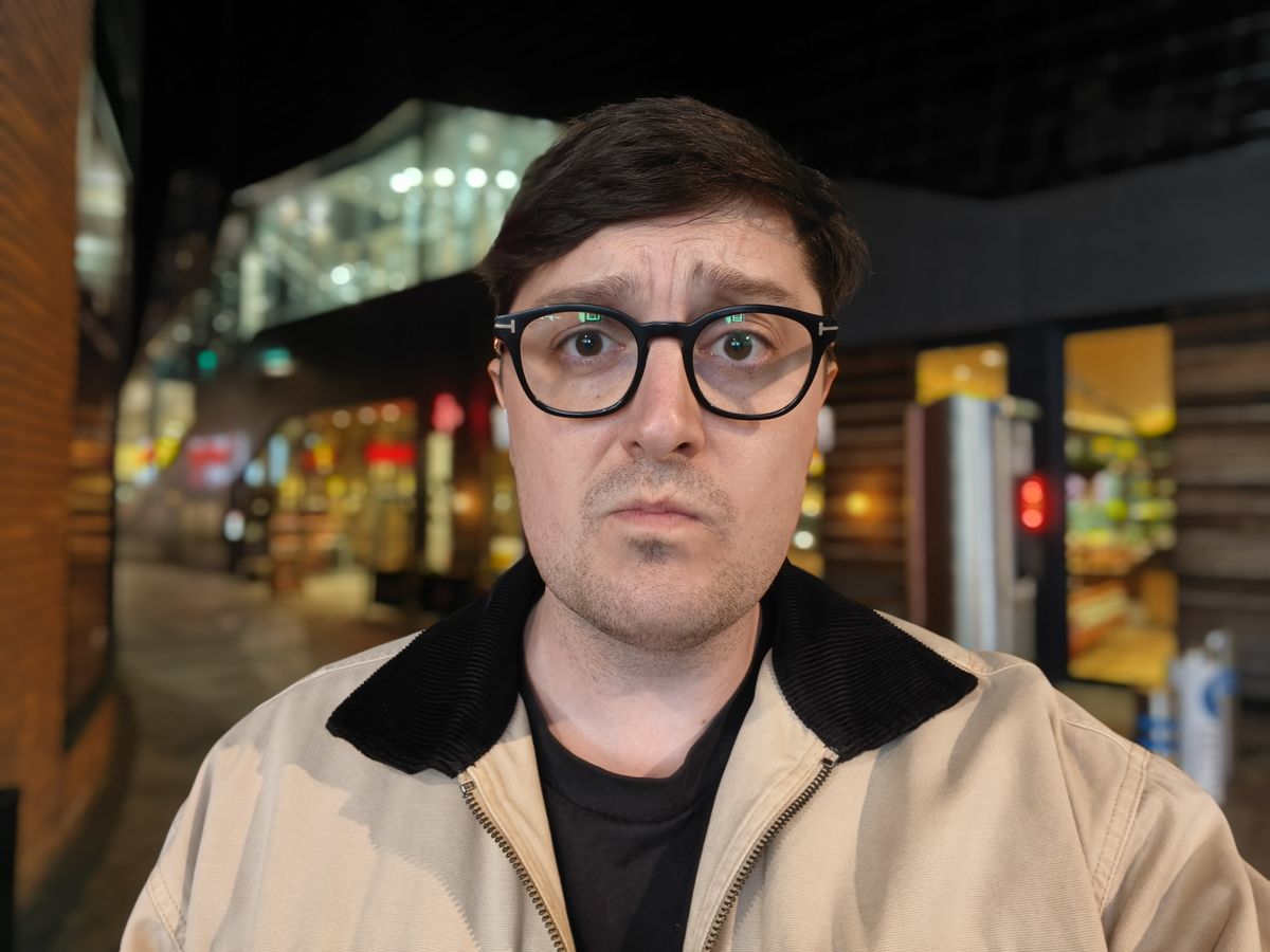 Person taking a selfie at night in a shopping centre