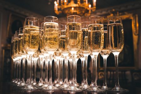 Glasses of Champagne stand on a bar table