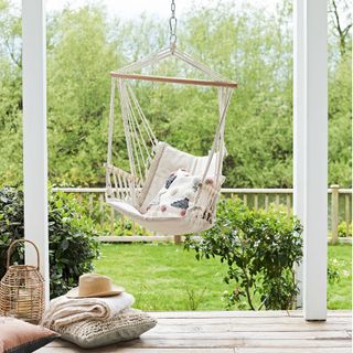 hanging chair on a decked verandah with view over the garden