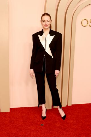 Emma Stone wearing a black and white suit for the Oscars Luncheon